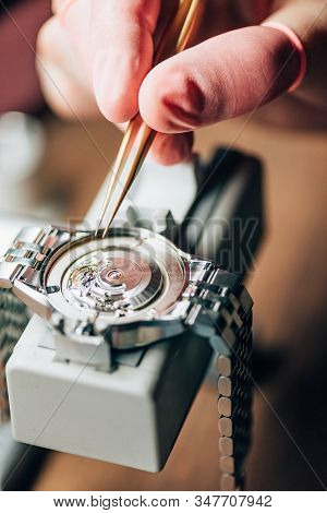 Close Up View Of Watchmaker Repairing Mechanical Wristwatch On Movement Holder