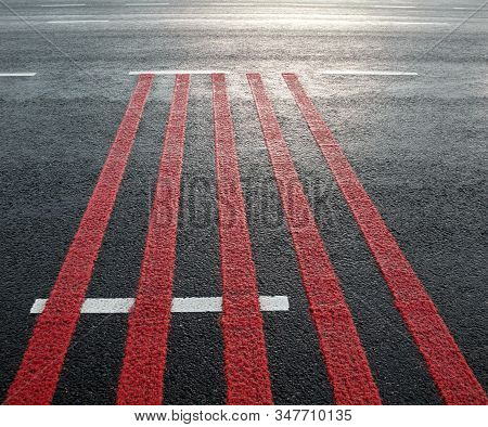 Red Rumble Strips On The Road. Sleeper Lines, Alert Strips, Audible Lines, Sleepy Bumps. Wake Up Cal