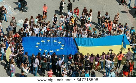 Lutsk, Volyn / Ukraine - May 17 2014: Young People Holding A Big Flags Of European Union And Ukraine