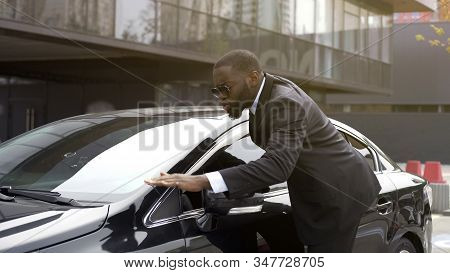 Personal Driver Of Important Person Wiping Dust From Chic And Shiny Auto