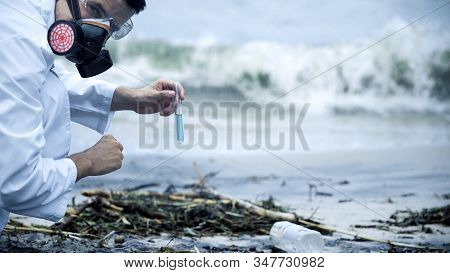 Toxicologist Checking Polluted Water, Splashing On Shore, Environmental Disaster