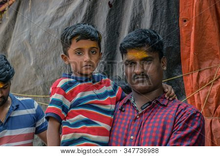 Son And Father Setting At Temple Steps In India