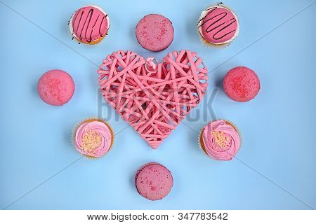 Wicker Pink Heart And Pink Cakes On A Light Blue Background, Top View