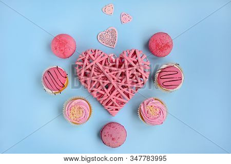 Layout For Valentine's Day. Wicker Pink Heart And Pink Cakes On A Light Blue Background, View