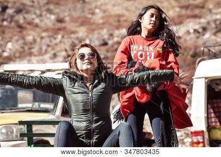 Happy Carefree Young Fashion Woman ( Asian Indian Ethenicity) Getting Out Of Car And Stretching Her 