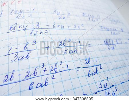 Math Formulas Are Written In A Notebook With A Pen. The Solution Of Examples And Problems In A Noteb