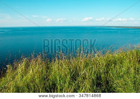 Beautiful Landscape Scenery Cliff Meadow, Water And Blue Sky. Cape Andoma, Karelia, Russia. Natural 