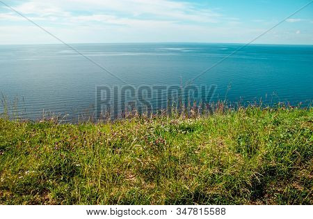 Beautiful Landscape Scenery Cliff Meadow, Water And Blue Sky. Cape Andoma, Karelia, Russia. Natural 