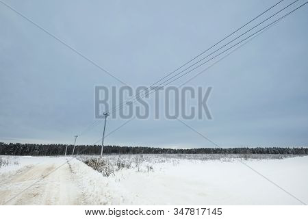 Blue Sky With Snow Field And Road. Great Background With Copyspace. Winter And Snow Landscape. Stock