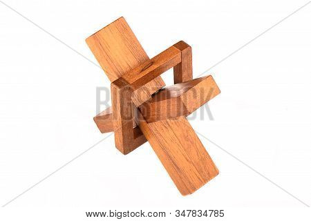 Assembled Wooden Cross Puzzle Isolated On A White Background.