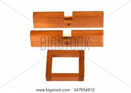 Single Pieces Of Wooden Cross Puzzle Isolated On A White Background.