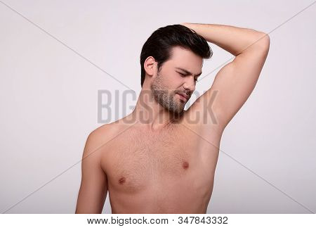 A Young Charming White Man, With A Beautiful Figure, Raised His Hand And Sniffed His Armpit. The Man