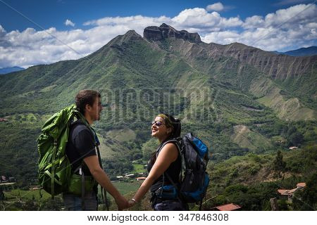 Backpacker Couple Holding Hands Surrounded By A Natural Landscape. Vilcabamba, Ecuador