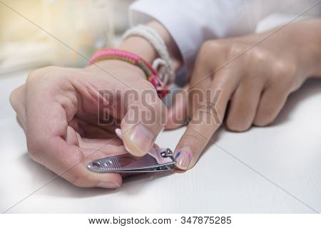 Cutting Nails That Are Painted And Showing The Middle Finger