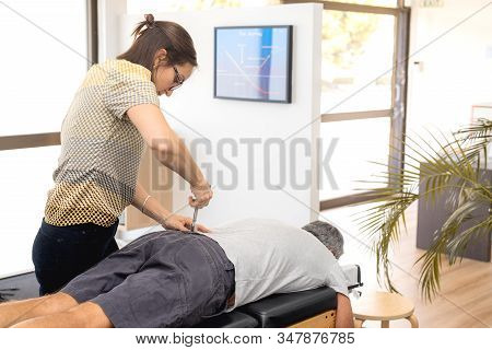 Man Having Chiropractic Back Adjustment. Physioterapy, Osteopathy, Alternative Medicine Pain Relief 