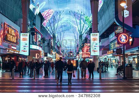 Las Vegas, Usa - December, 2019 Tourists Outside The Pioneer Watch The Freemont Street Experience Li