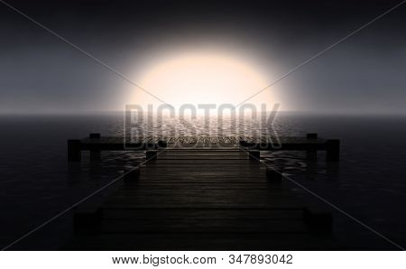 A Wooden Boat Jetty Jutting Out Across Calm Water With The Sun Rising On The Horizon In Dim Light - 