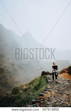 Santo Antao Island, Cape Verde. Tourist Female On Stony Hiking Path To Ponta Do Sol Over Arid Aranha