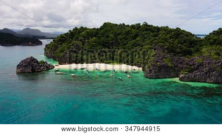 Tropical Island With Sandy With Tourists And Blue Sea, Aerial View. Lahos Island, Caramoan Islands, 