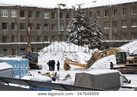 January 20, 2020. Novosibirsk, Russia. Excavators Destroy An Old Building. Winter, Snow, A Group Of 