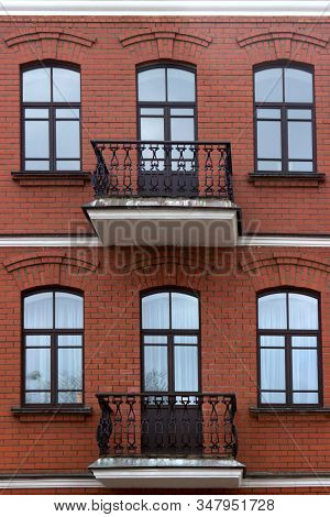 Red Brick European Building Facade With Exposed Metal Wrought Iron Retro Vintage Balconred Brick Eur