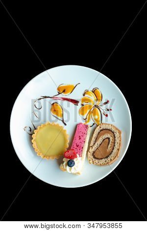 A White Plate Decorated With Food Coloring Flowers To Display Three Individual Cakes