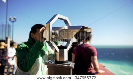 Tourist Looking Through Binoculars At Observation Deck, Man Admiring Seascape