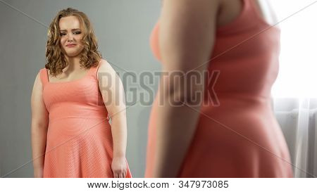 Young Female Looking In Mirror With Disgust, Ashamed Of Fat Body, Obesity Issue