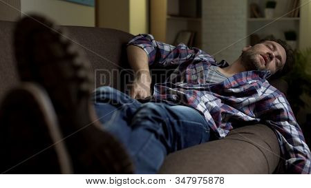 Untidy Drunkard Sleeping On Couch After Home Party, Alcoholism Consequences