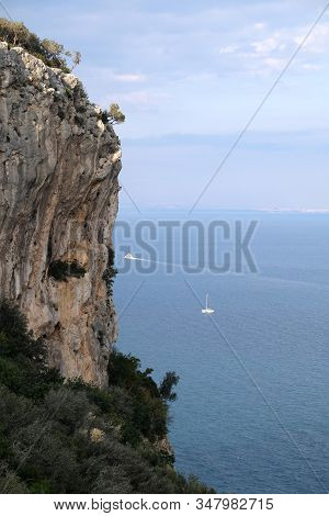High Impregnable Plateau With Mountain Vegetation On Top And Calm Sea Far And Down On Skyline On Sun