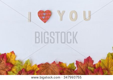Love Day Concept. The Wooden Text Remain To Valentine's Day With Maple Leaf And White Background.val