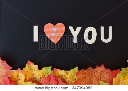 Love Day Concept. The Wooden Text Remain To Valentine's Day With Maple Leaf And Black Background.val