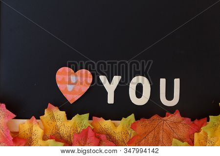 Love Day Concept. The Wooden Text Remain To Valentine's Day With Maple Leaf And Black Background.val