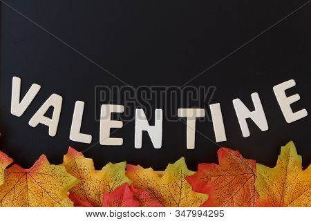 Love Day Concept. The Wooden Text Remain To Valentine's Day With Maple Leaf And Black Background.val