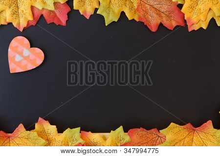 Love Day Concept. The Mini Heart Remain To Valentine's Day With Maple Leaf And Black Background.vale