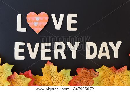 Love Day Concept. The Wooden Text Remain To Valentine's Day With Maple Leaf And Black Background.val