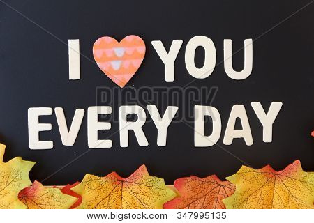 Love Day Concept. The Wooden Text Remain To Valentine's Day With Maple Leaf And Black Background.val