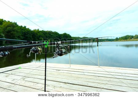 Carp Fishing On Beautiful Blue Lake With Carp Rods And Rod Pods In The Summer Morning. Fishing From 