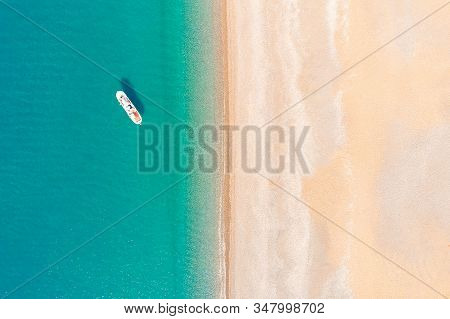 The White Yacht Is On The Roadstead Not Far From The Shore. Top View From A Quadrocopter.