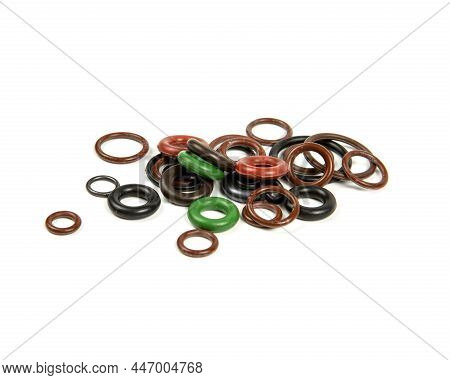 Hydraulic And Pneumatic O-rings In Different Sizes And Colors, On A White Background. Various Seals 