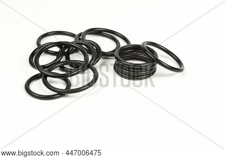 Black Hydraulic And Pneumatic O-rings In Different Sizes On A White Background. O-rings For Hydrauli