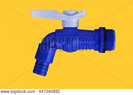Blue Pvc Plastic Faucet On Yellow Background