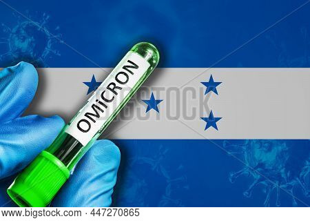 Honduras Outbreak Of Omicron Variant. A Hand In A Blue Rubber Glove Holds A Test Tube With Covid-19 