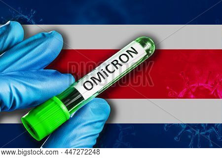 Costa Rica Outbreak Of Omicron Variant. A Hand In A Blue Rubber Glove Holds A Test Tube With Covid-1