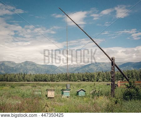 The Landscape With Shadoof And Hives On The Mountain Background Colored