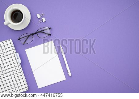 Top View Desk With Office Supplies On Purple Background