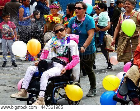 Cuenca, Ecuador - February 22, 2020: Young Man In Wheel Chair Participate In Carnival Parade In Cuen