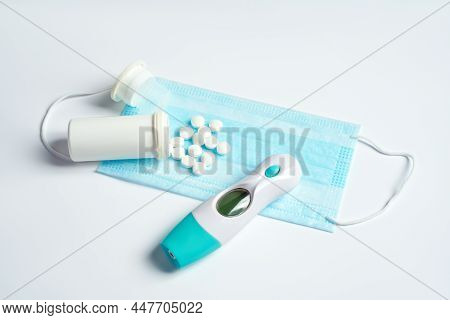Protective Face Mask, Tablets Or Pills And Thermometry On White Background