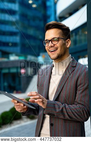 Successful Happy Business Man Working On Digital Tablet In Urban Background