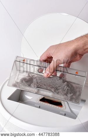 Take Out The Transparent Dust Container From The Robot Vacuum Cleaner After Cleaning The House. The